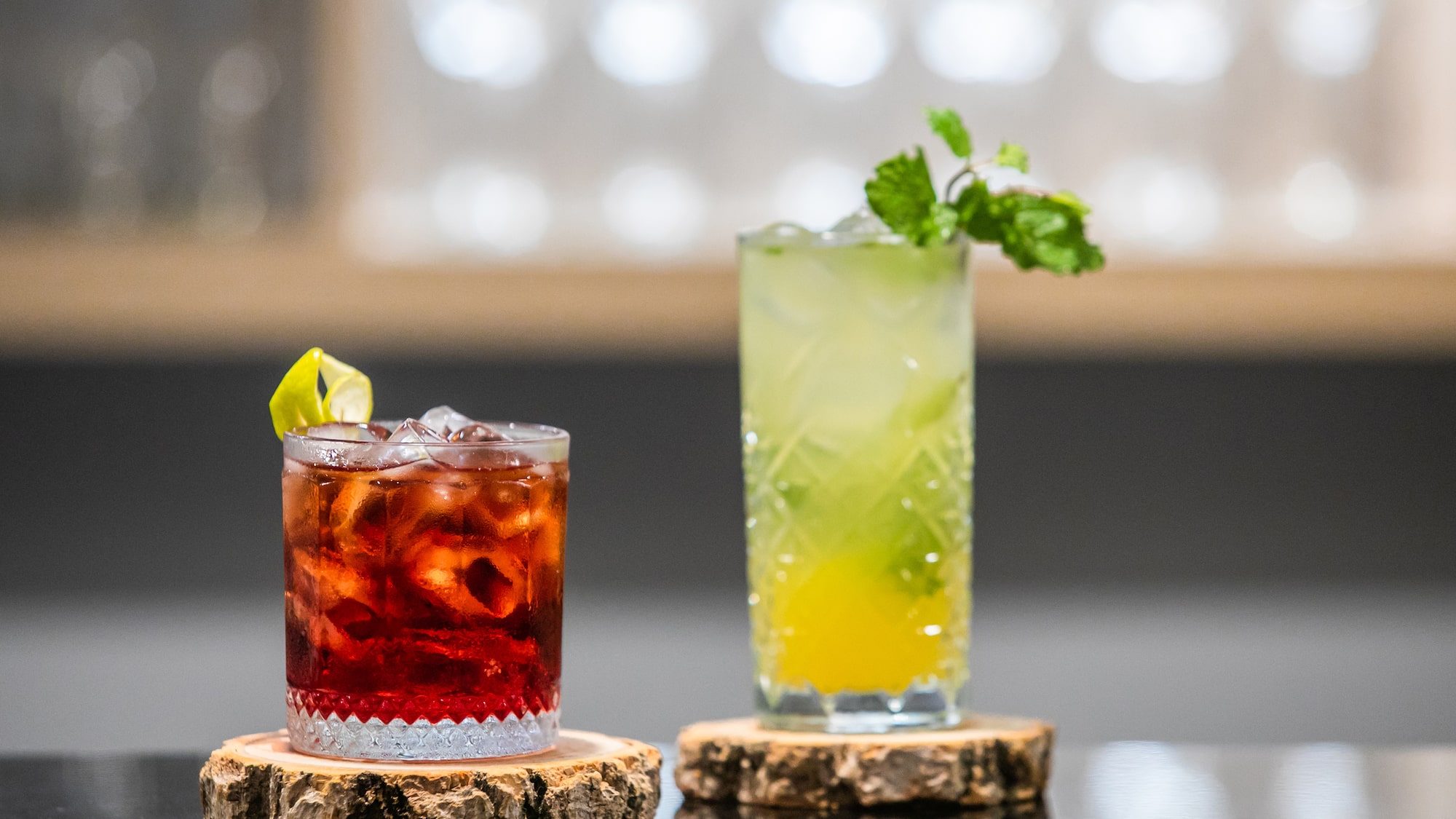 two glasses of drinks on a table