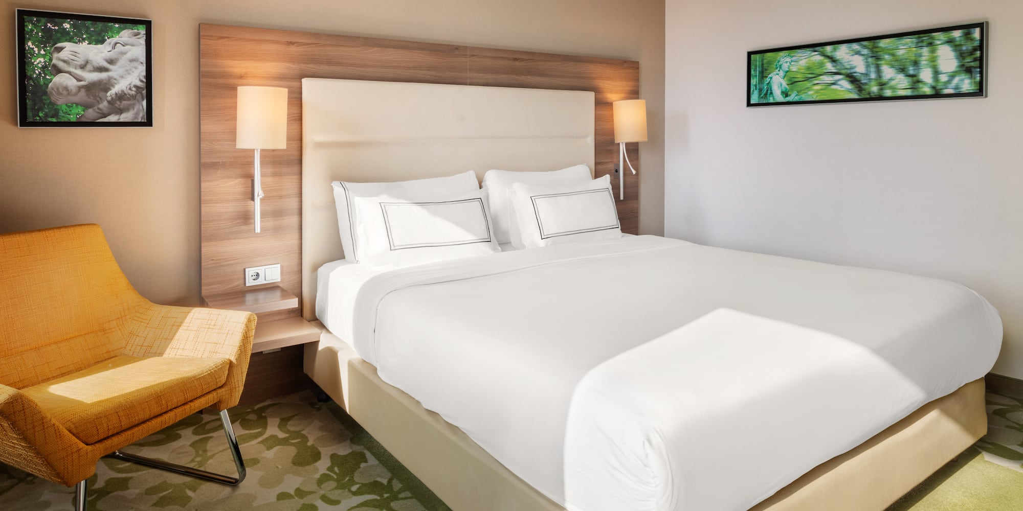 a bed with white sheets and a chair in a room