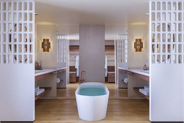 a bathroom with a tub and sinks