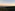 Sunrise over green valleys, distant Rock of Gibraltar, city, and wind turbines.