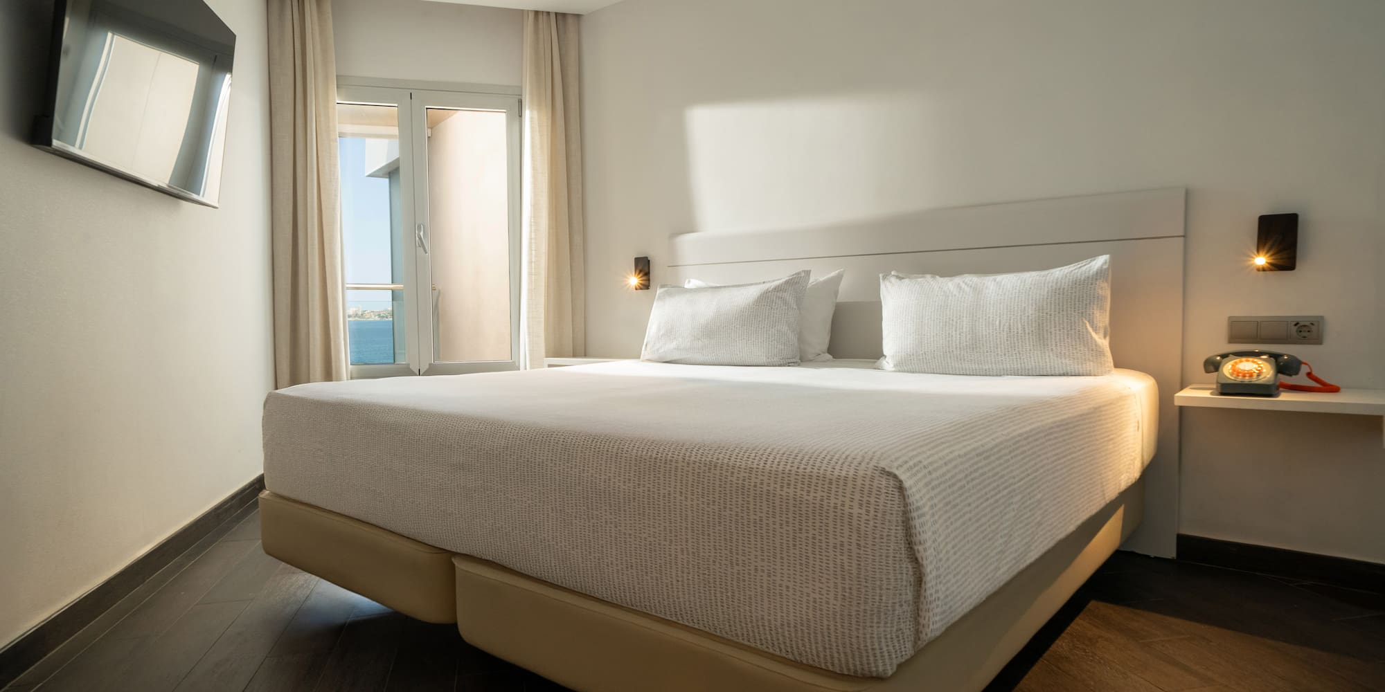 a bed with a light on the side