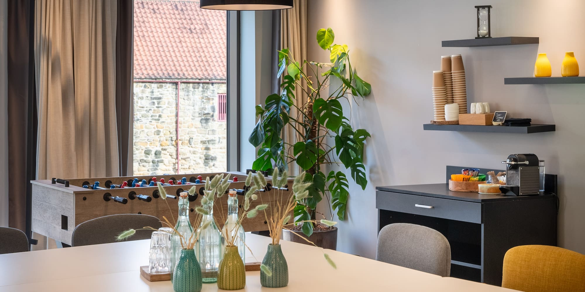 a room with a table and a foosball table
