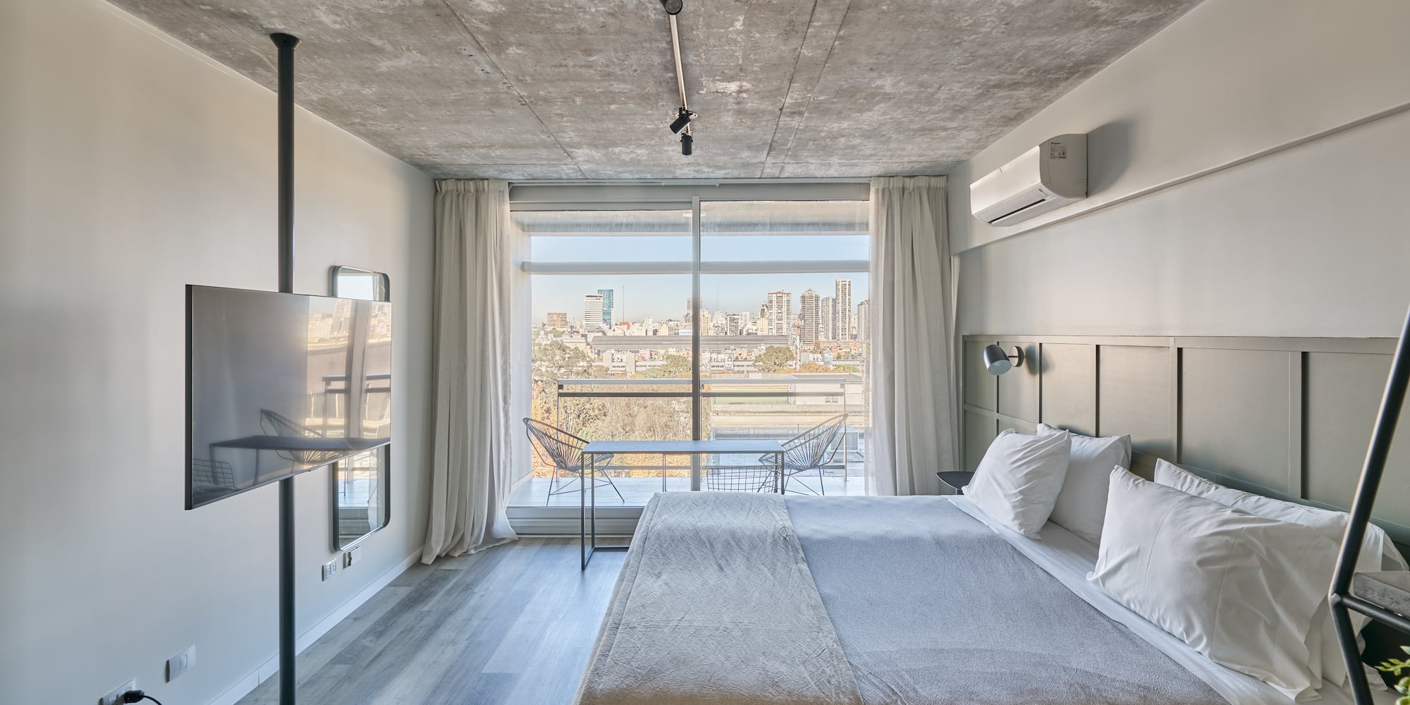 a bedroom with a large bed and a television