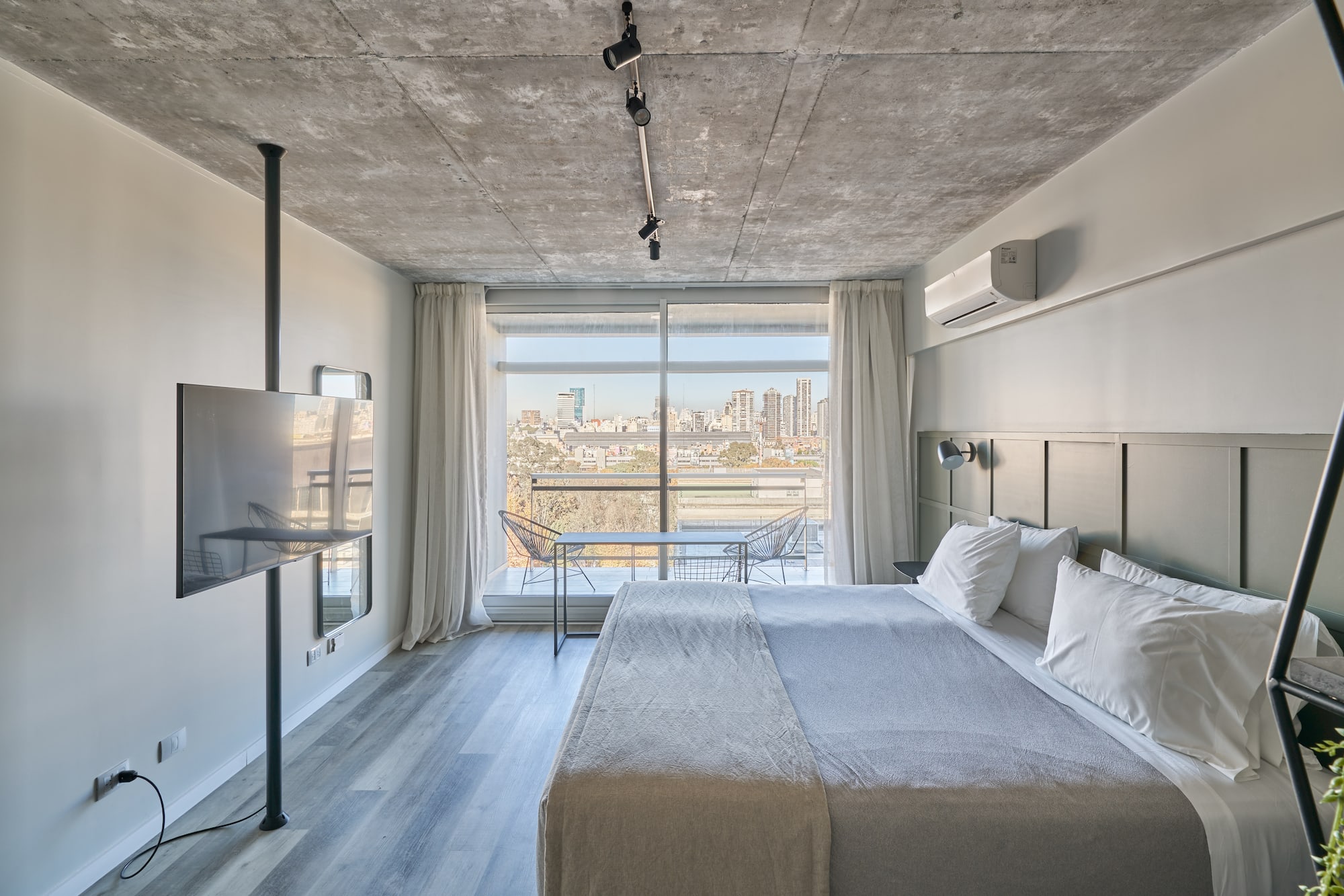 a bedroom with a large bed and a television