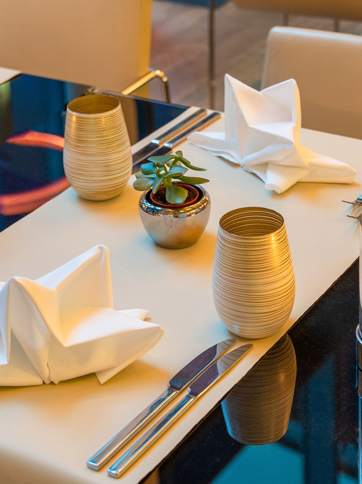 a table with silverware and napkins