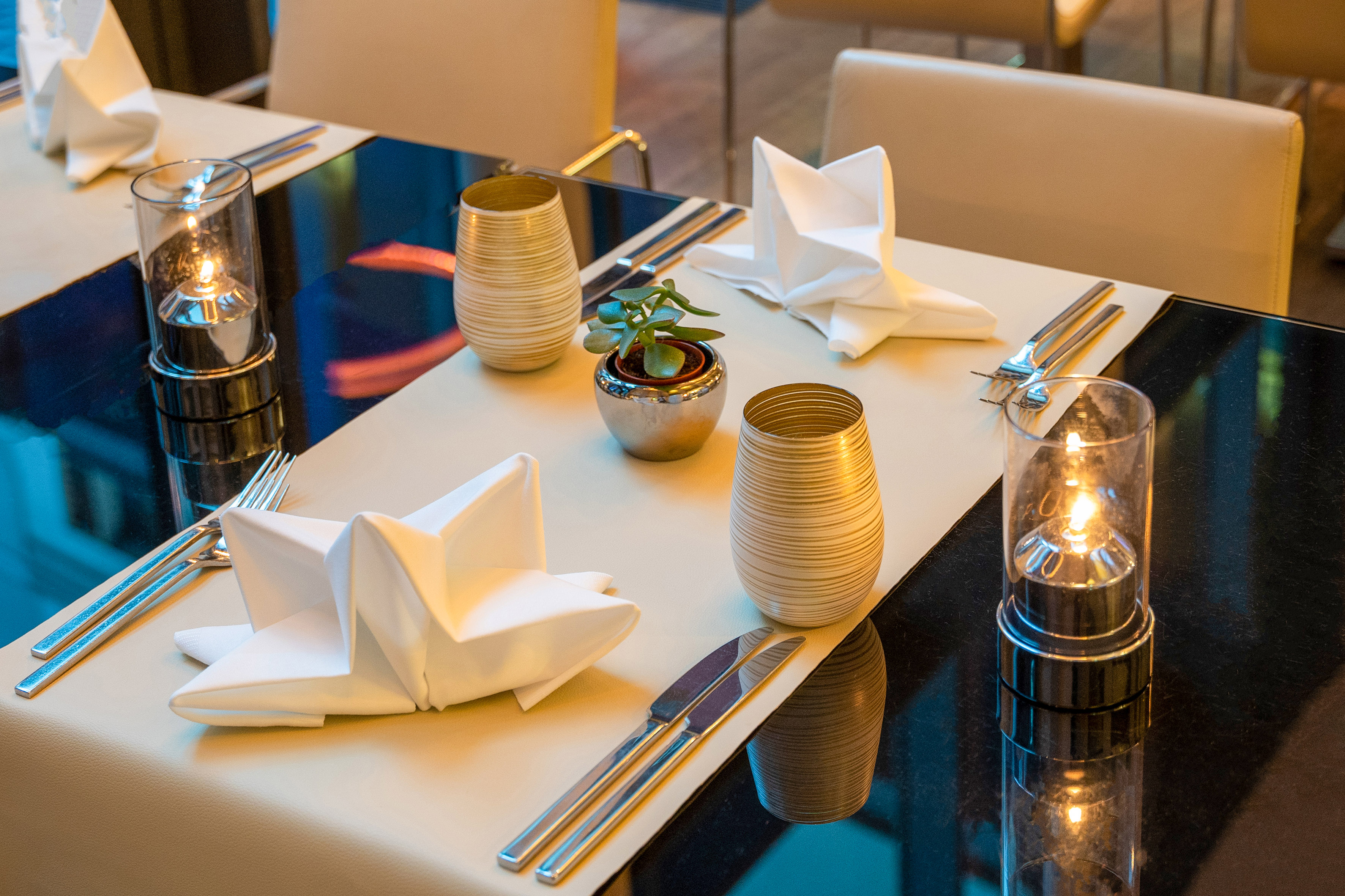 a table with silverware and napkins