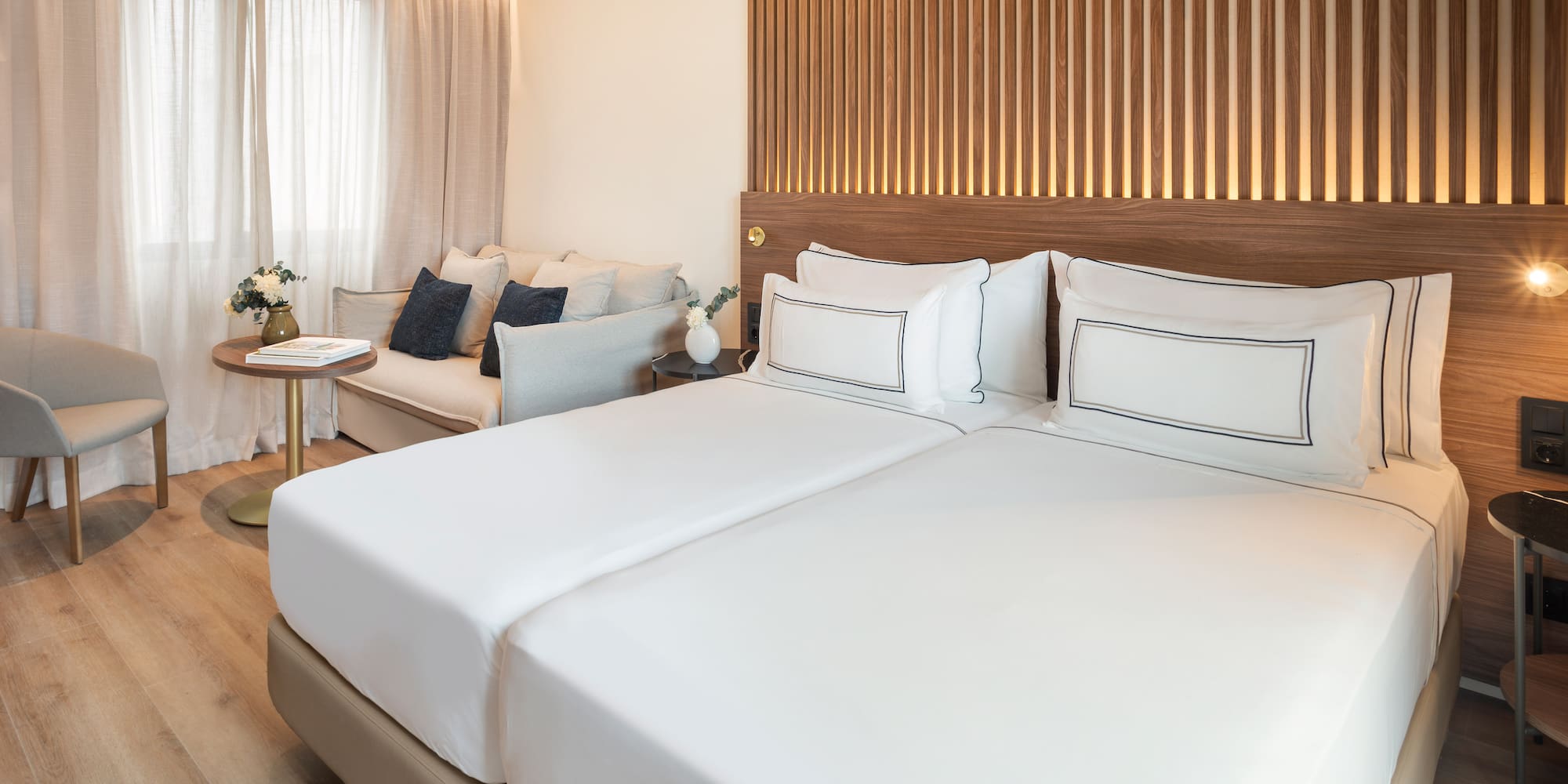 a room with two beds and a couch