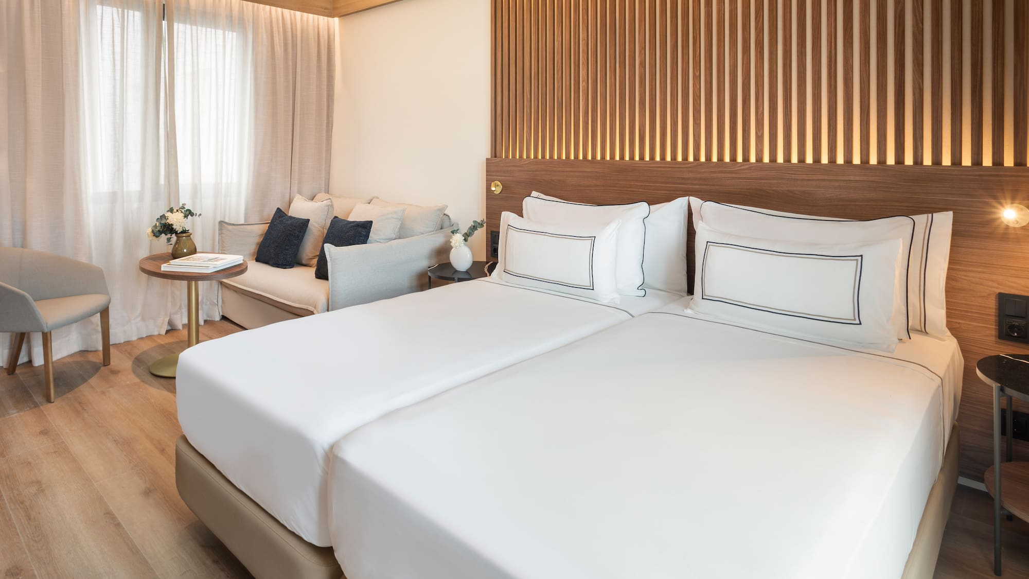 a room with two beds and a couch