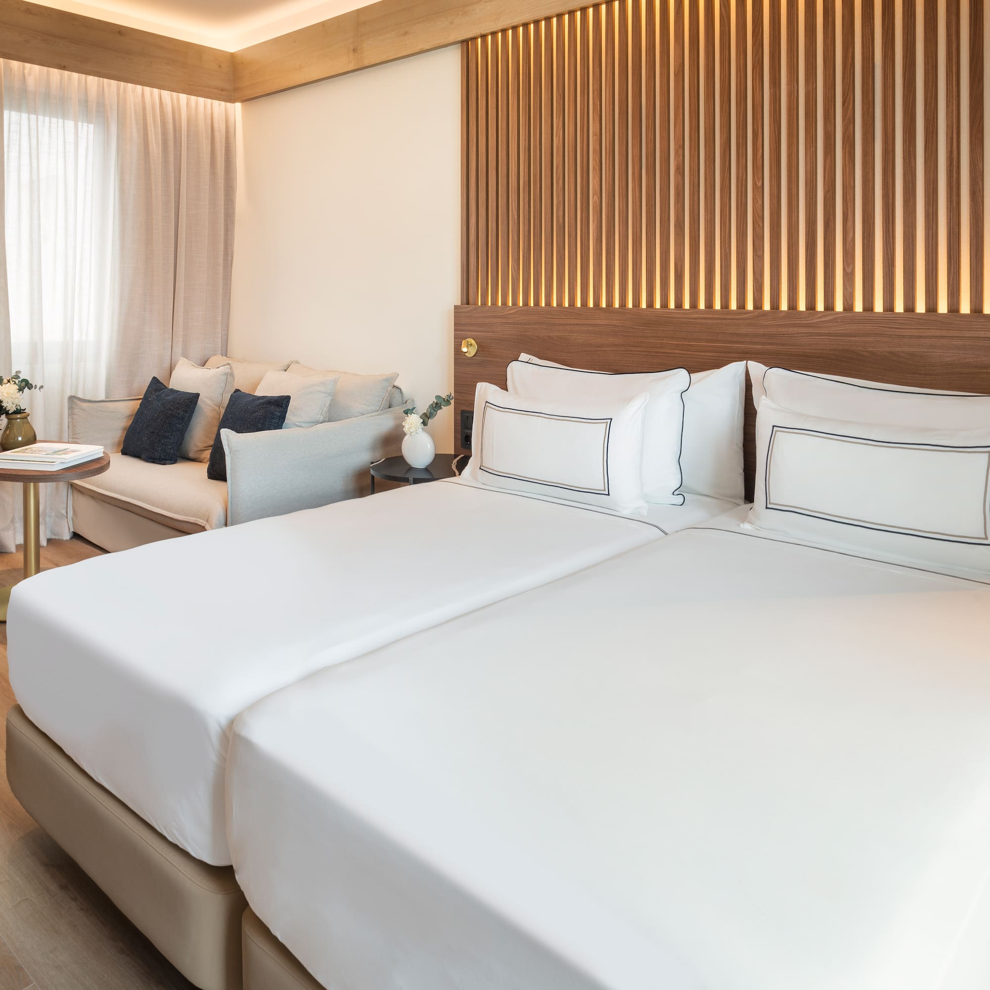 a room with two beds and a couch