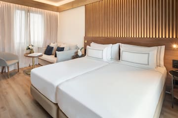 a room with two beds and a couch