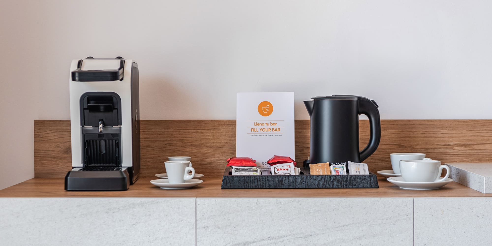 a coffee machine and cups on a counter