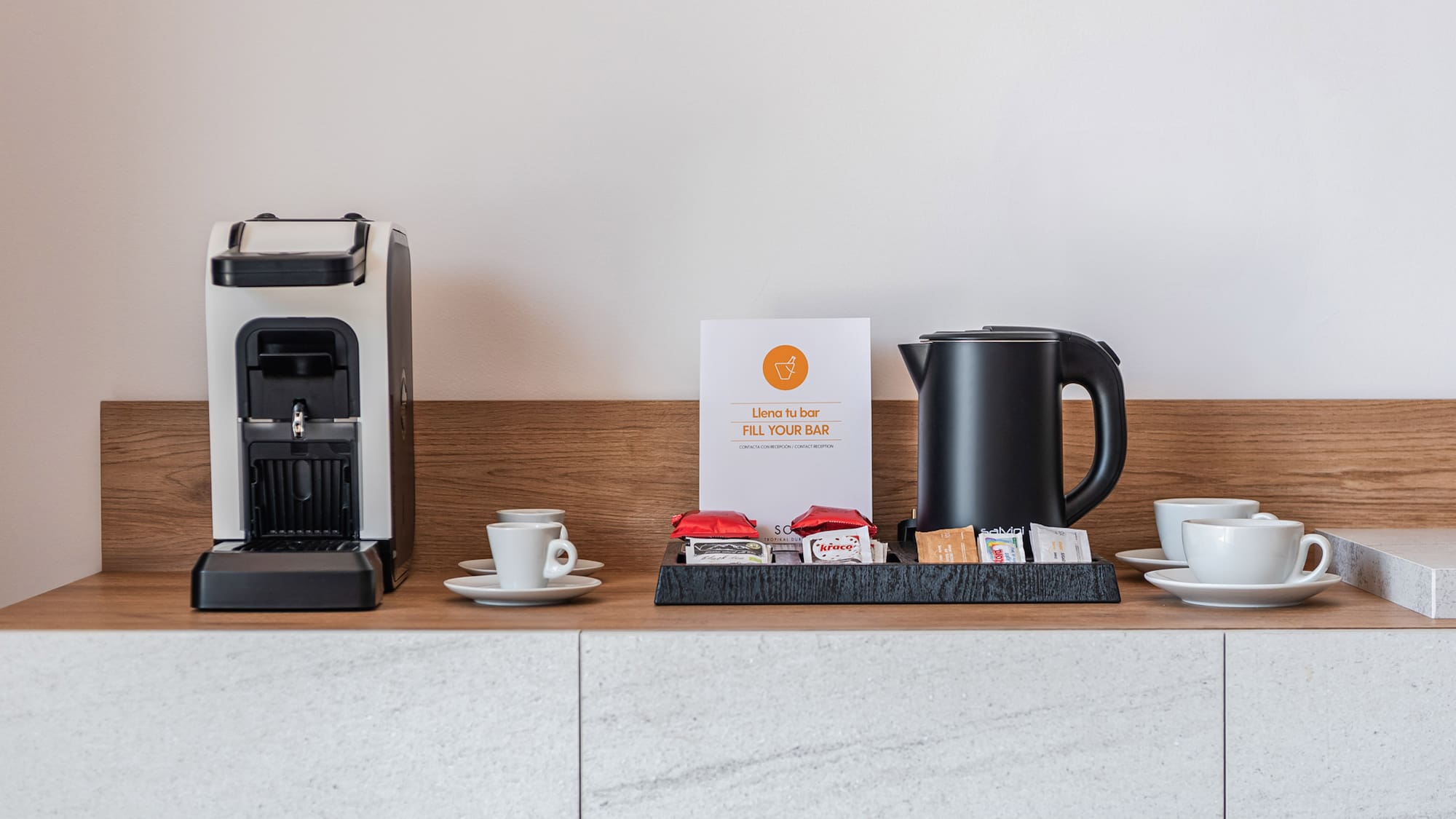 a coffee machine and cups on a counter