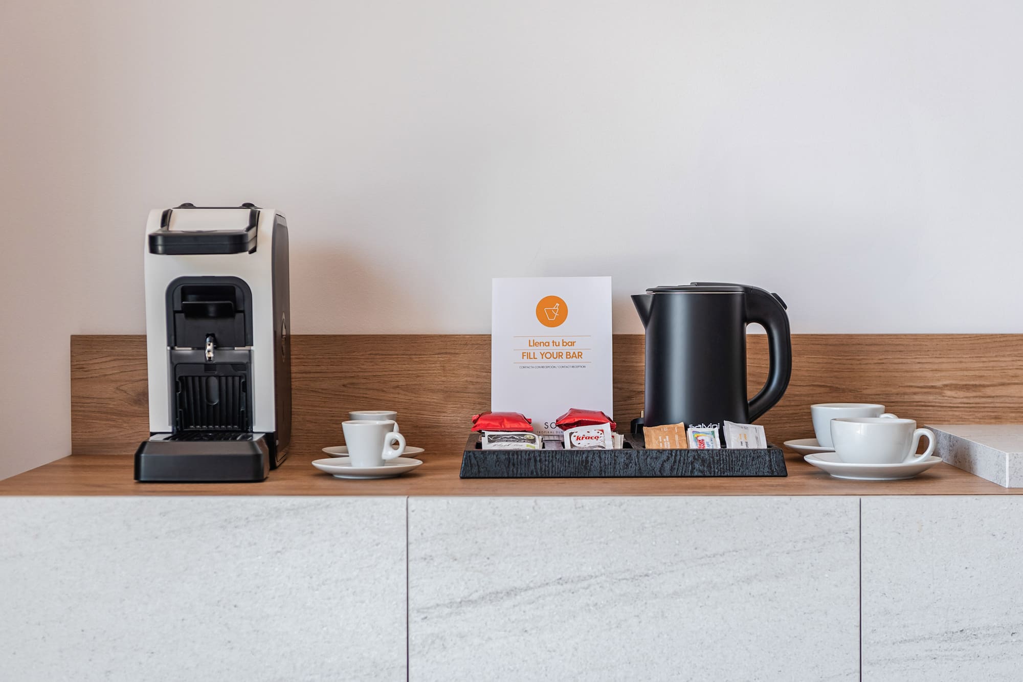 a coffee machine and cups on a counter