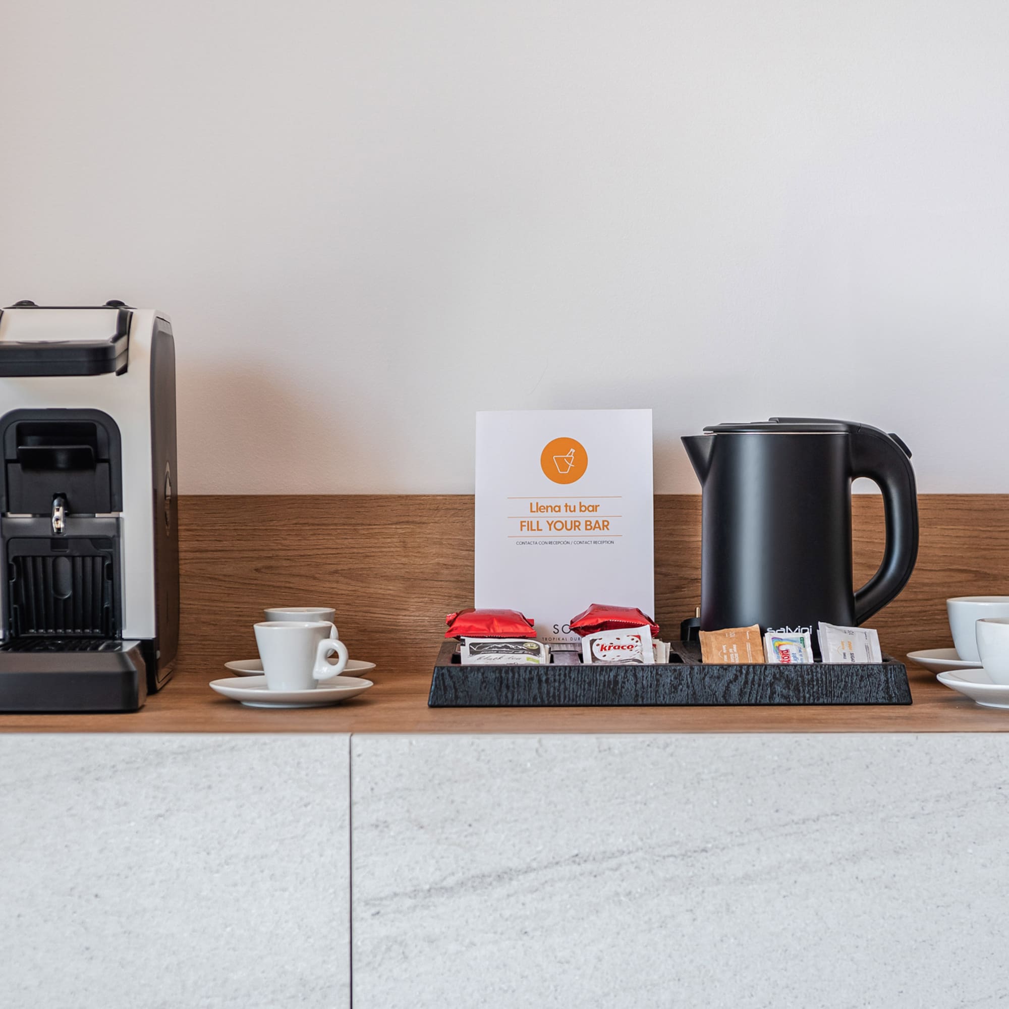 a coffee machine and cups on a counter