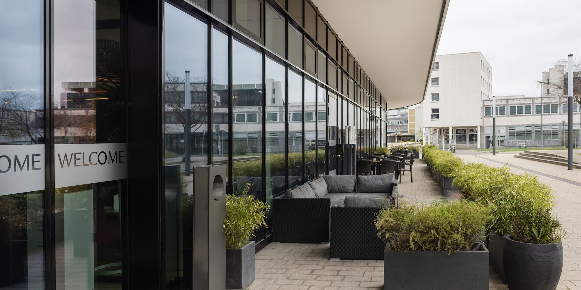 a building with glass windows and furniture