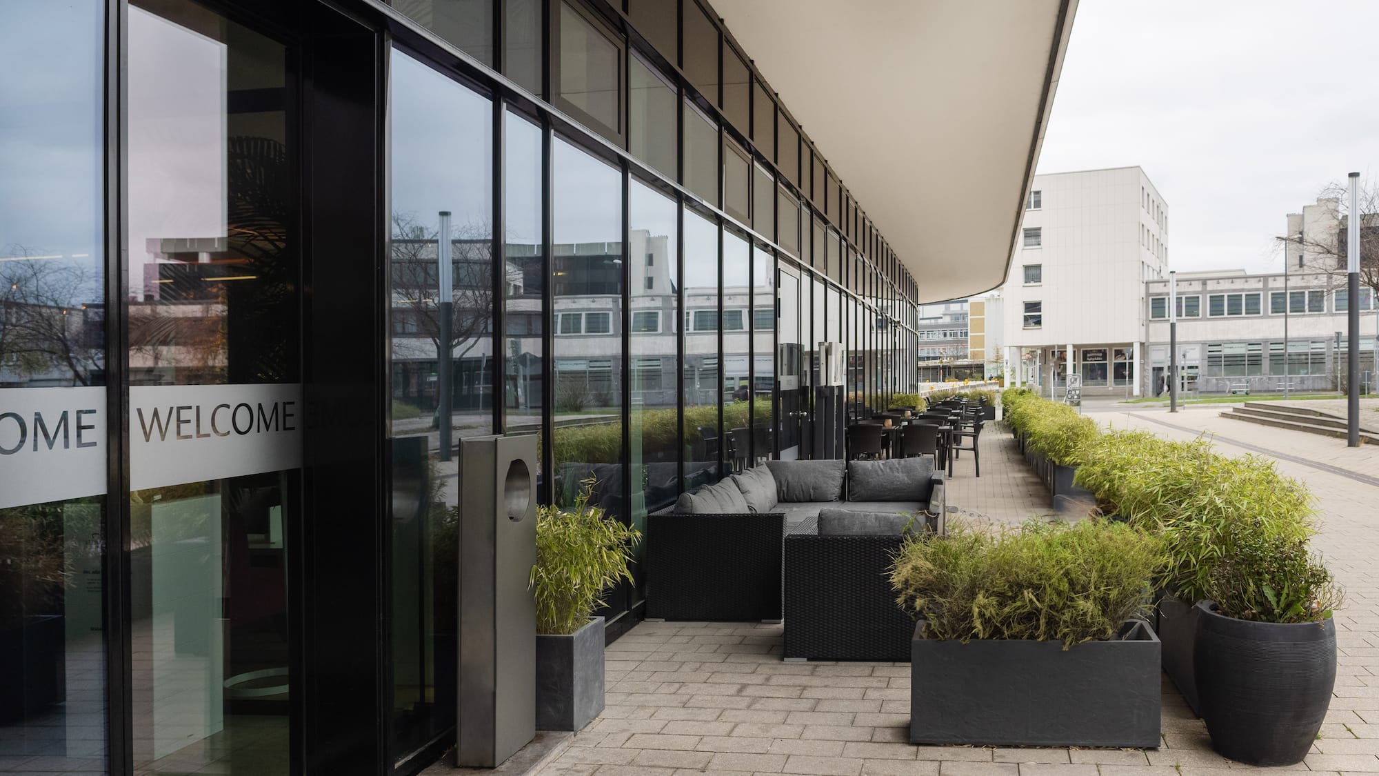 a building with glass windows and furniture