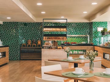 a room with a green wall and a table with food