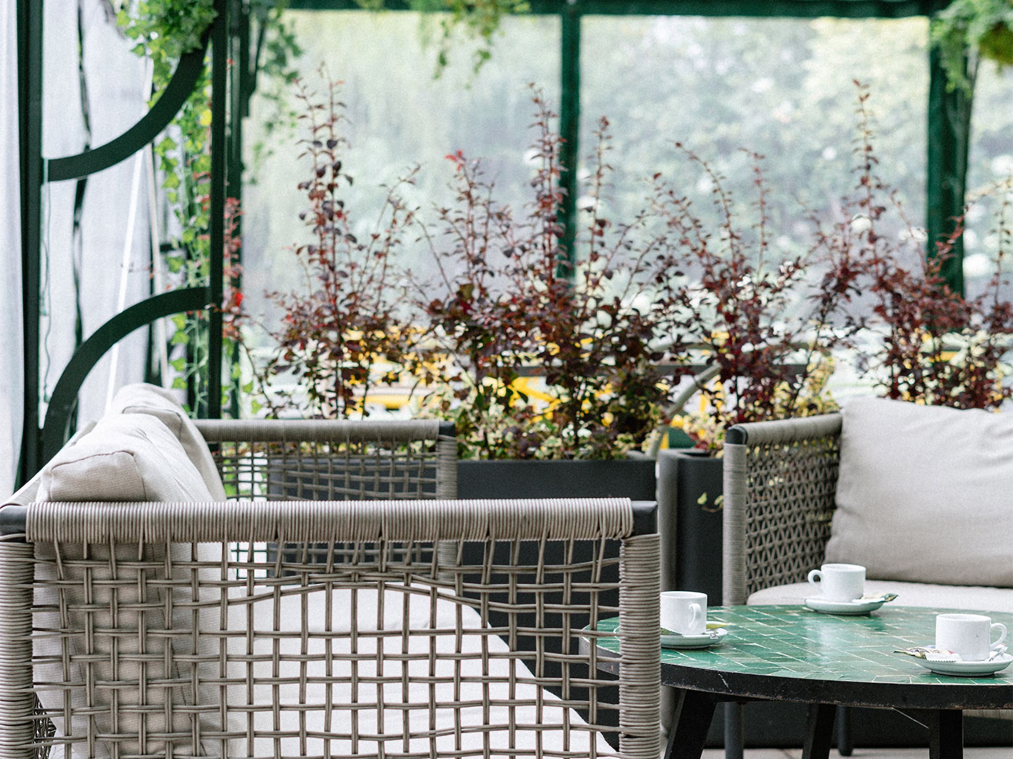 a patio with a glass covered patio with a table and chairs