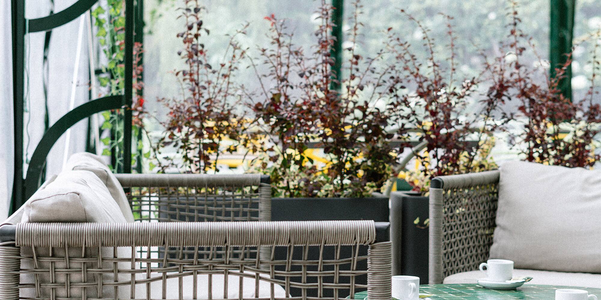 a patio with a glass covered patio with a table and chairs