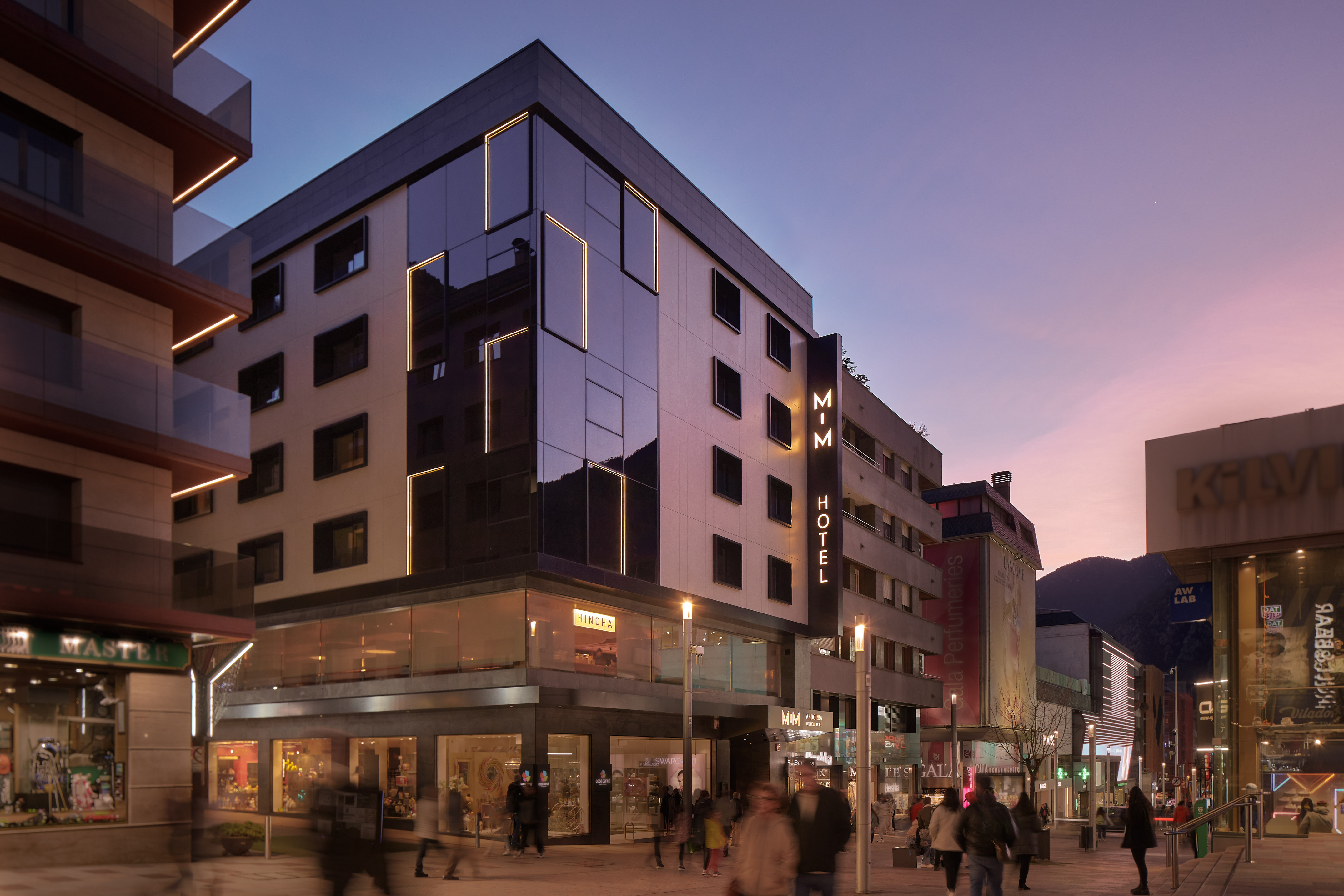 a building with many windows and people walking around