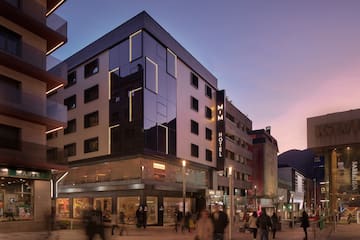 a building with many windows and people walking around