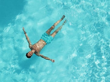a man floating in a pool