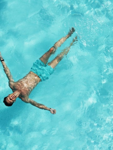 a man floating in a pool