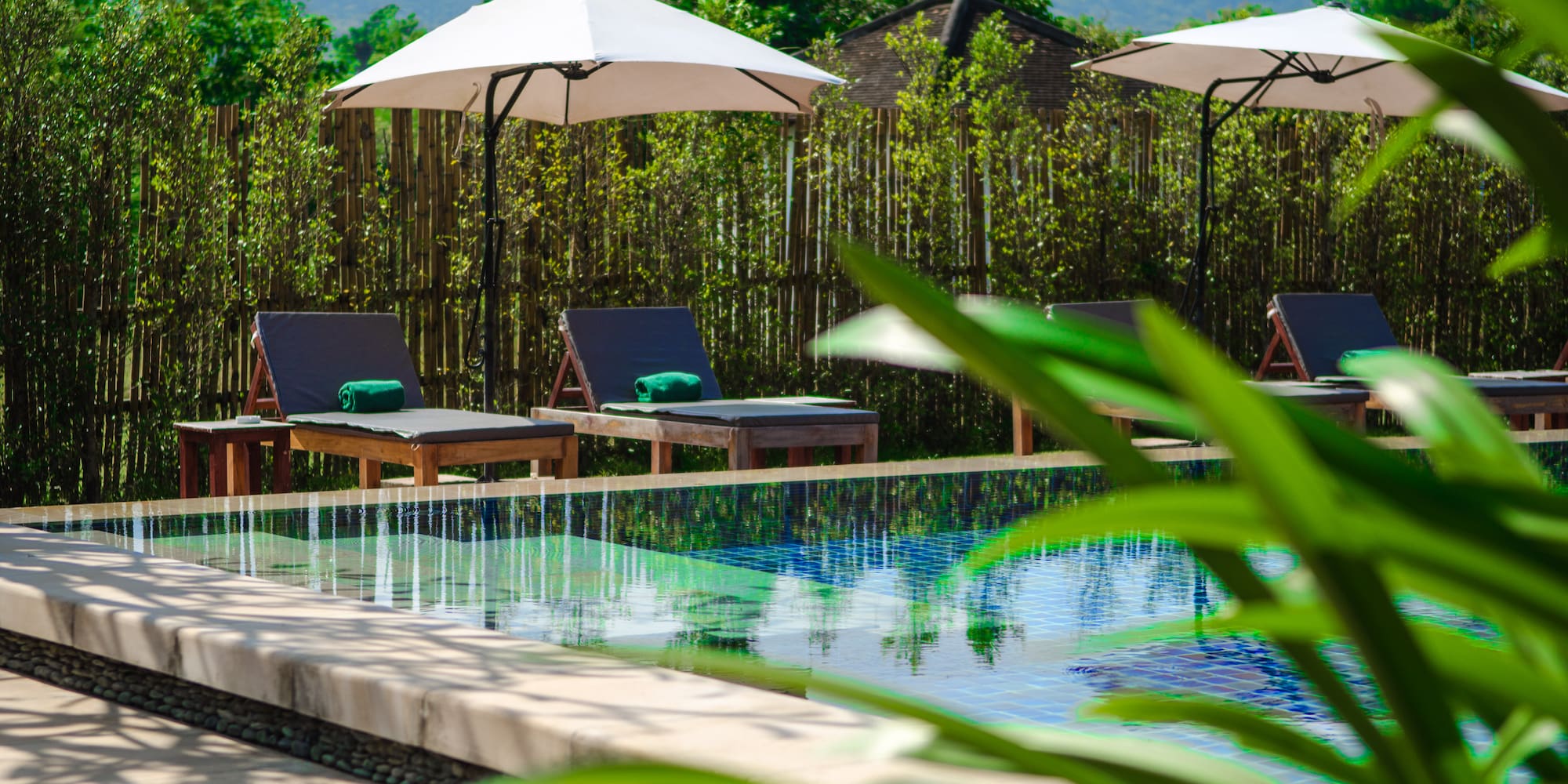 a pool with chairs and umbrellas