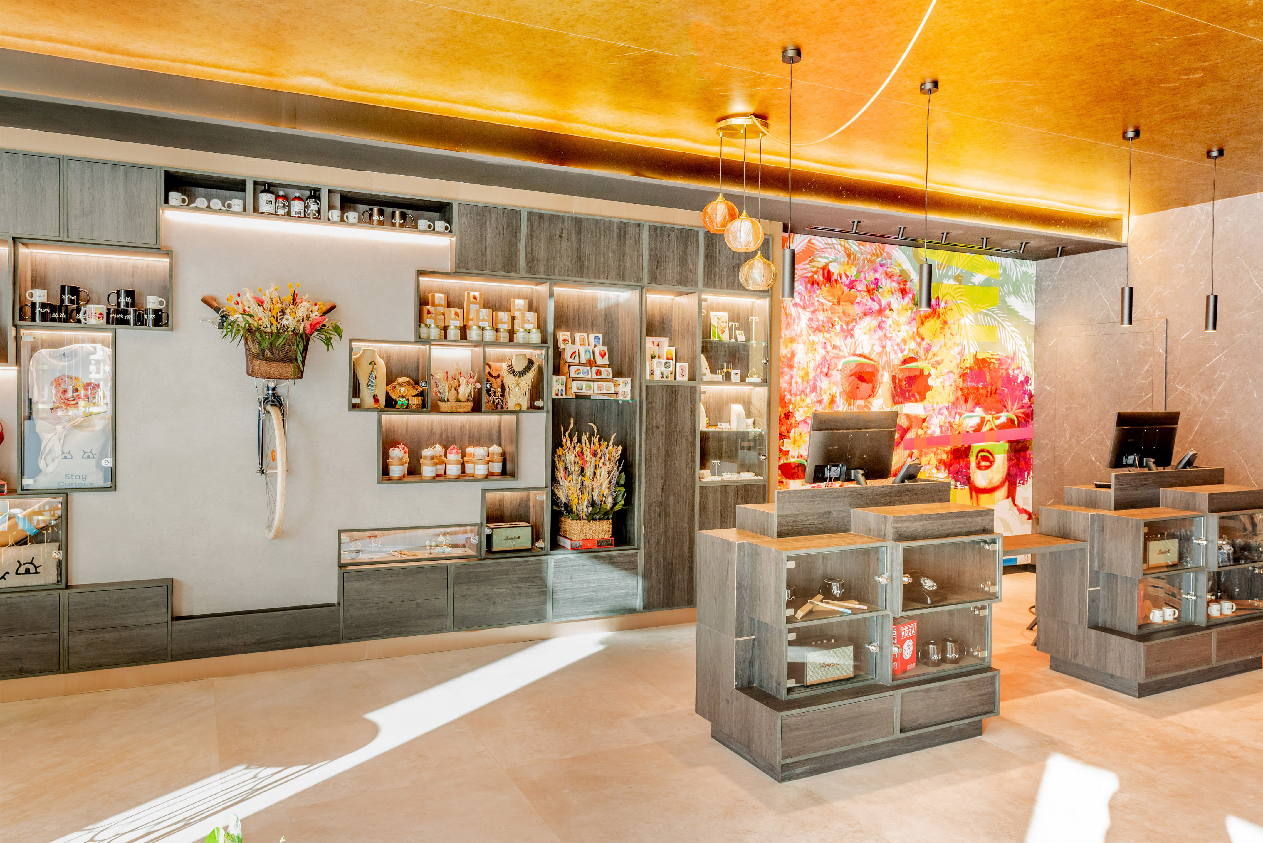 Modern retail store interior with product displays, checkout counters, and vibrant wall art.