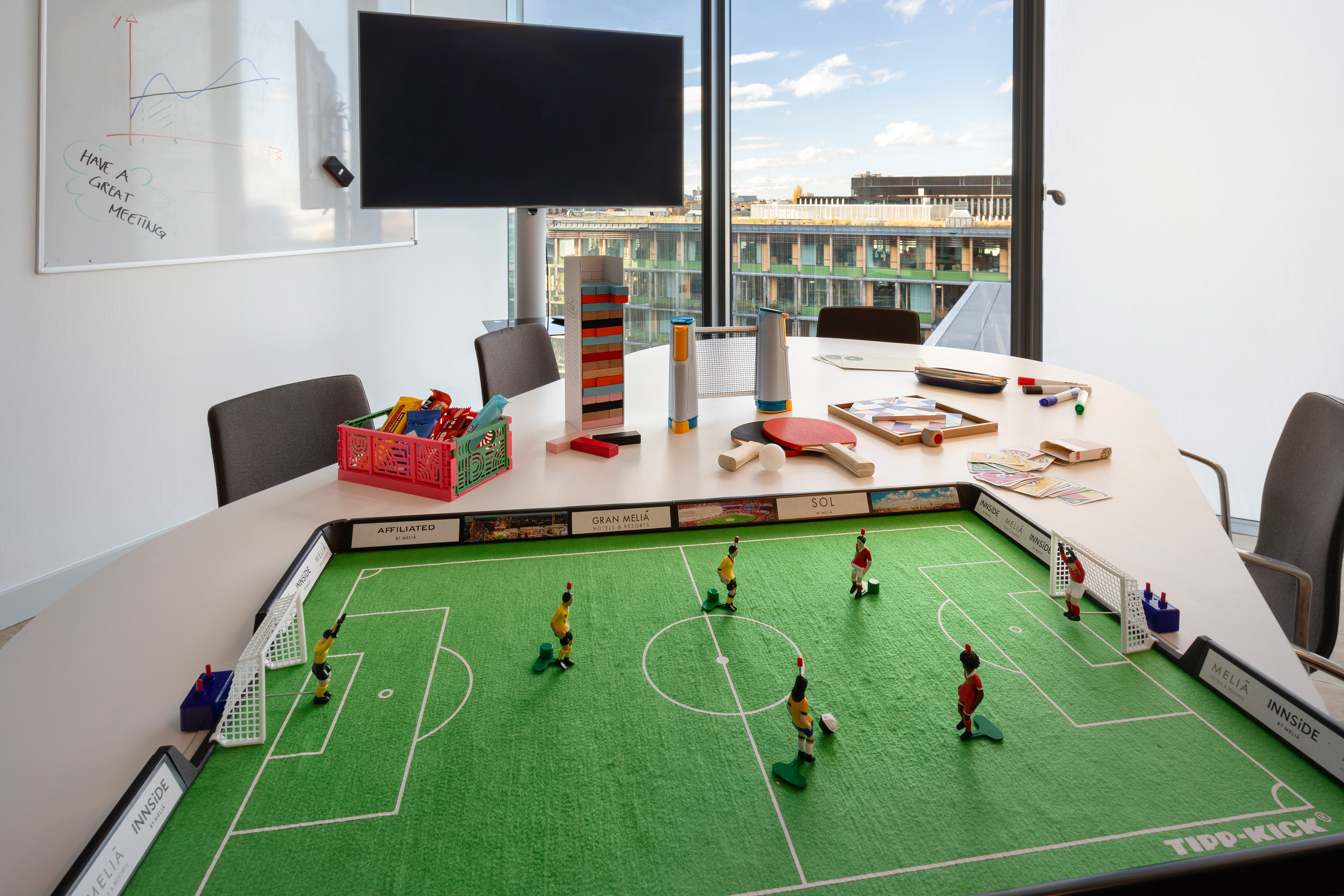 TIPP-KICK football game setup in a modern office meeting room.