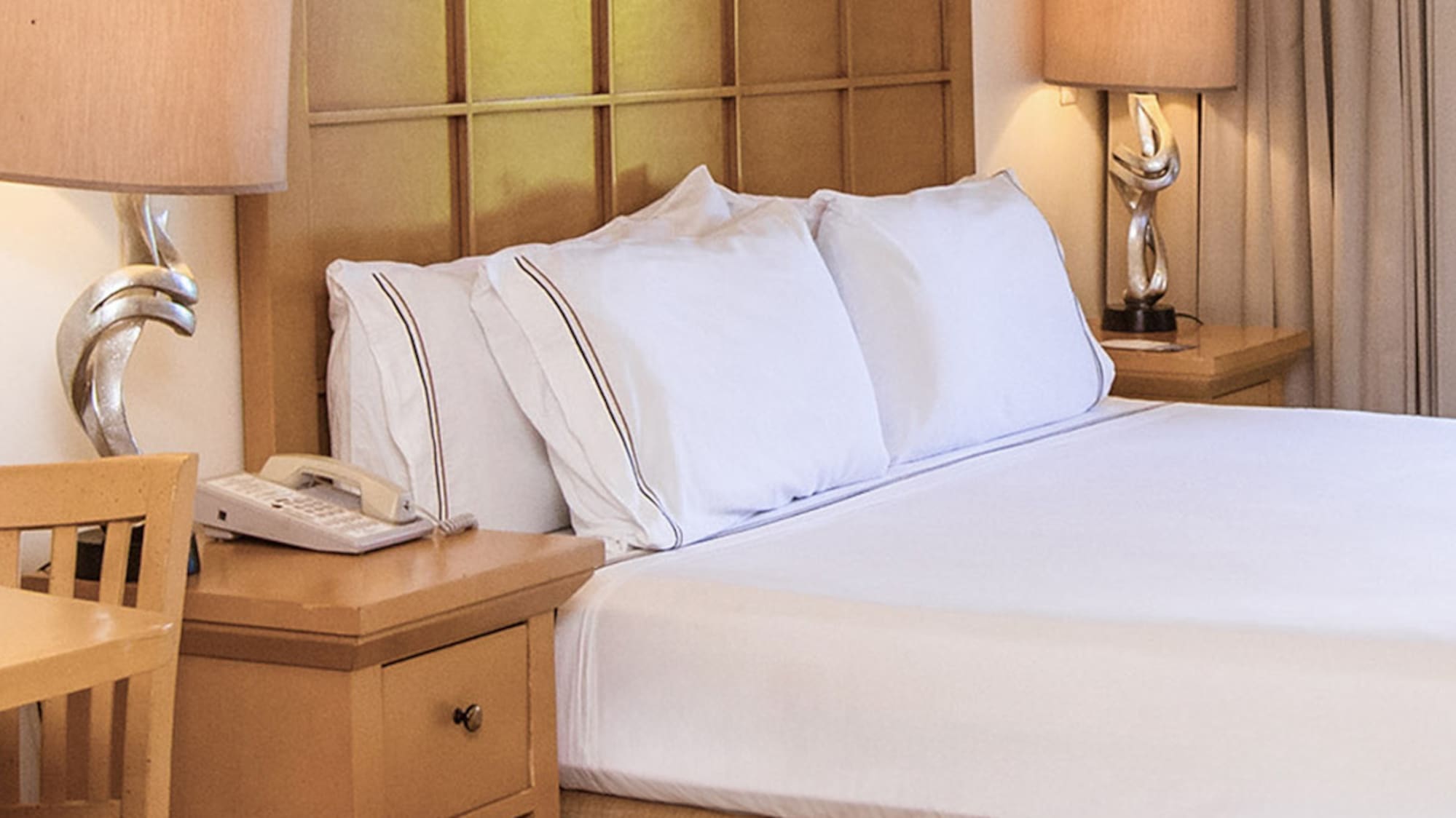 a bed with a telephone and table