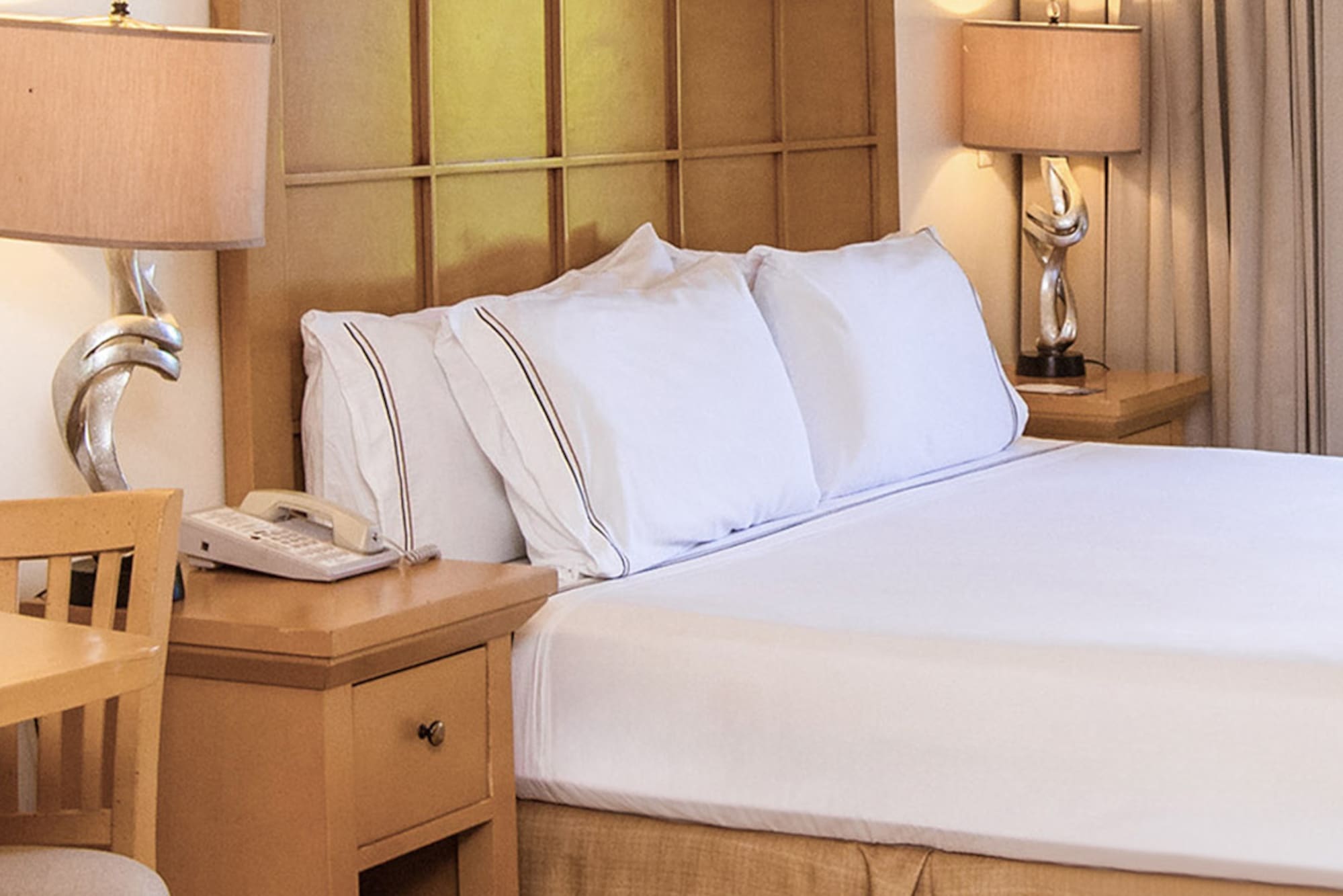 a bed with a telephone and table