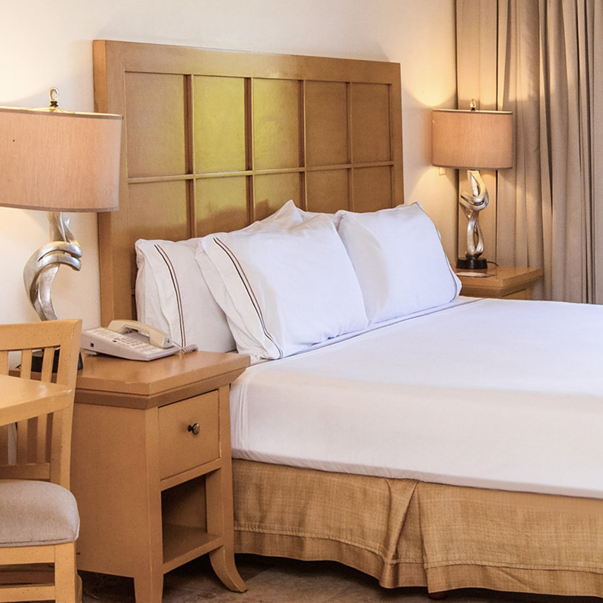 a bed with a telephone and table