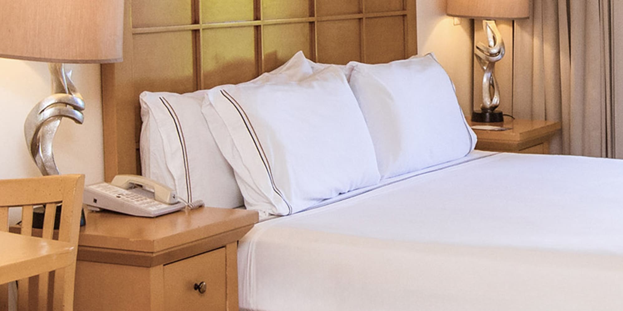 a bed with a telephone and table