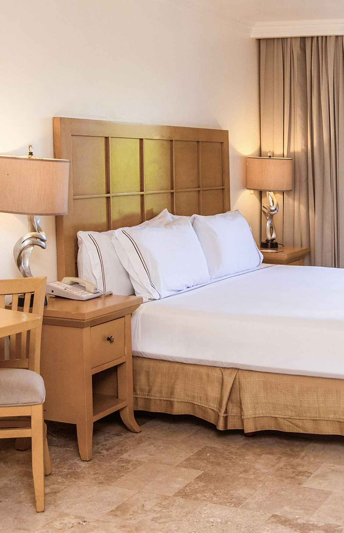 a bed with a telephone and table