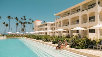 a man and woman sitting on a pool side