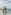 Family looking at panoramic ocean and city view from glass skydeck.