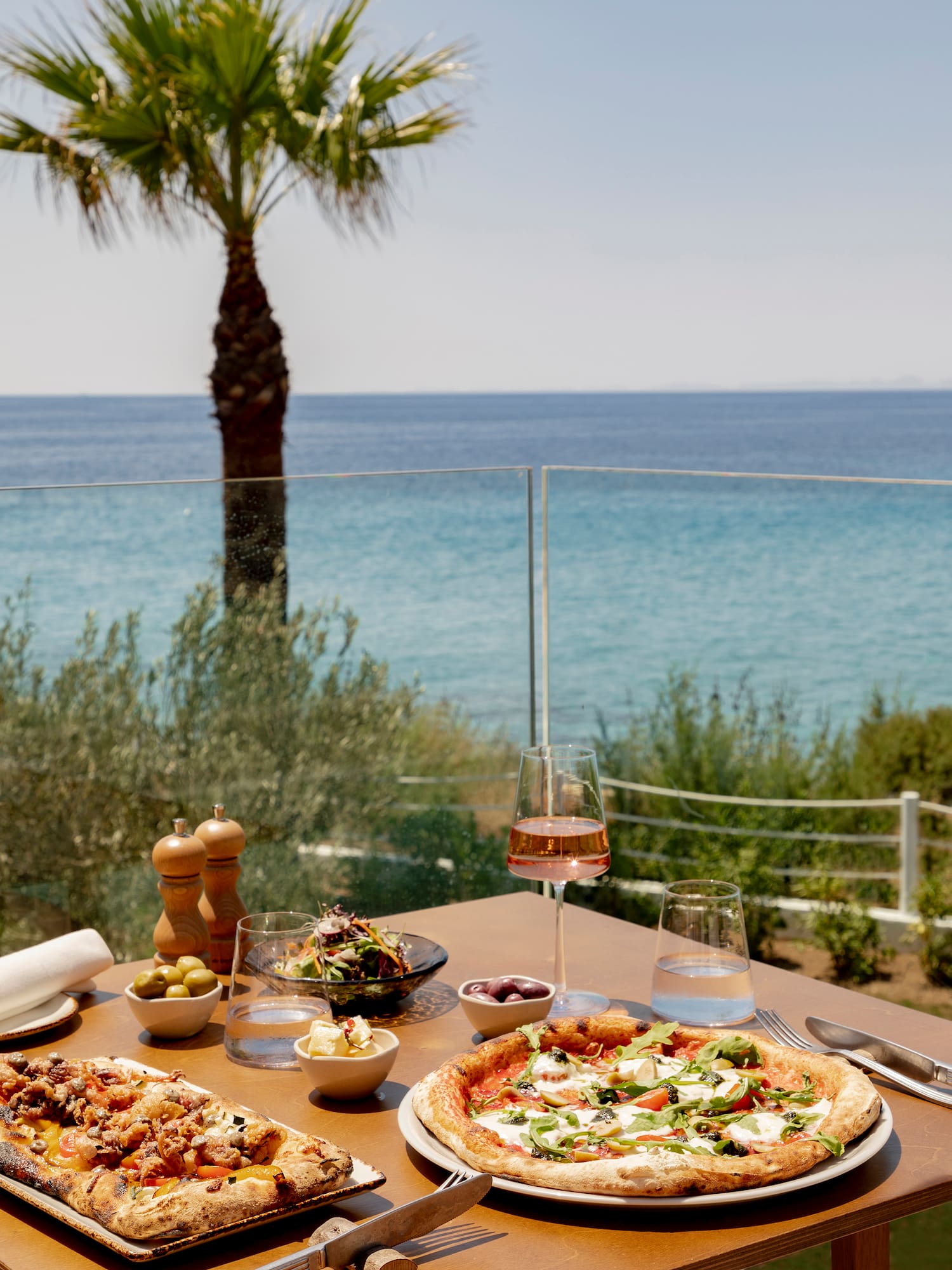 a table with food on it and a glass of wine on it