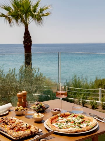 a table with food on it and a glass of wine on it