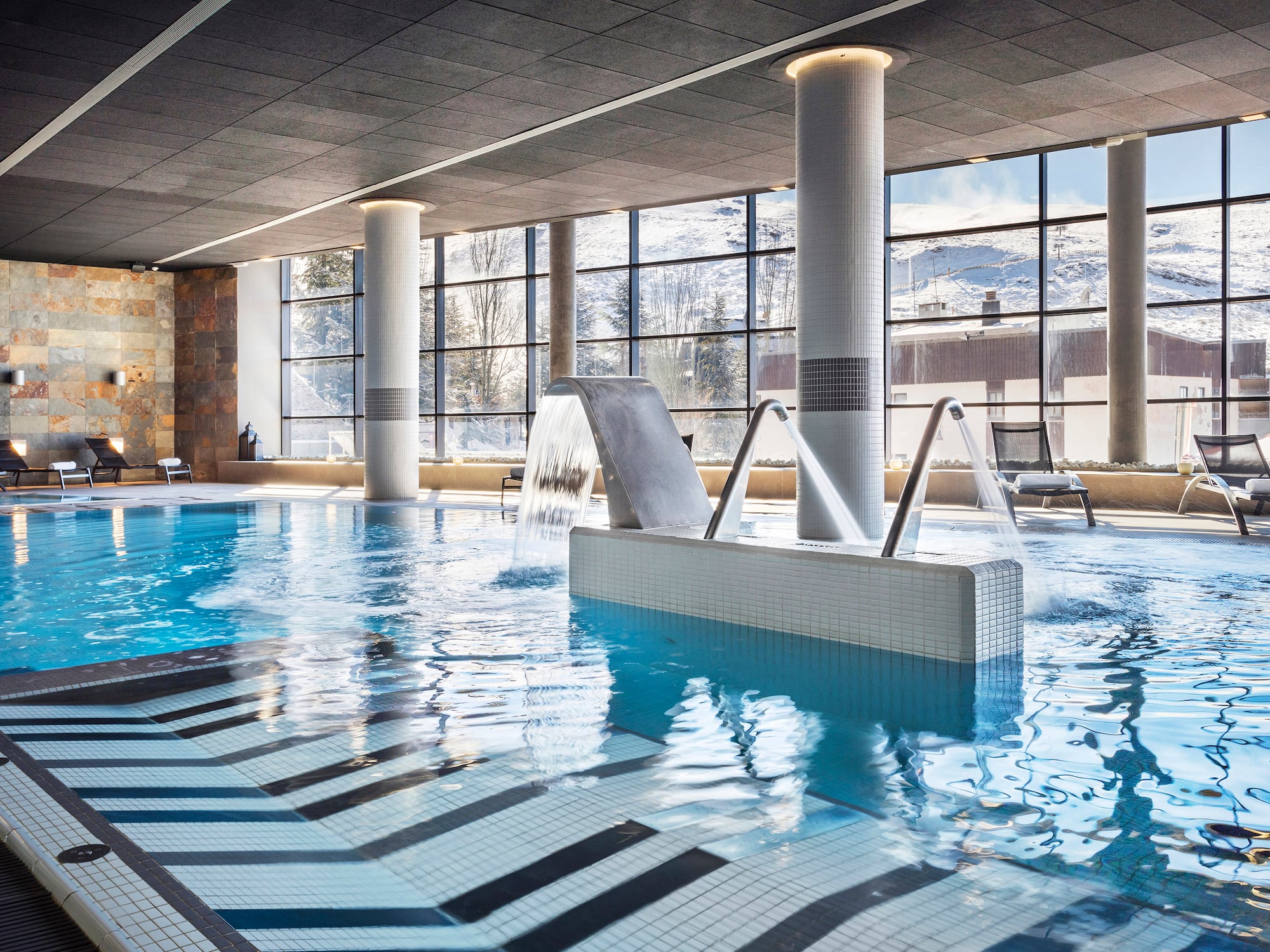 a swimming pool with a waterfall