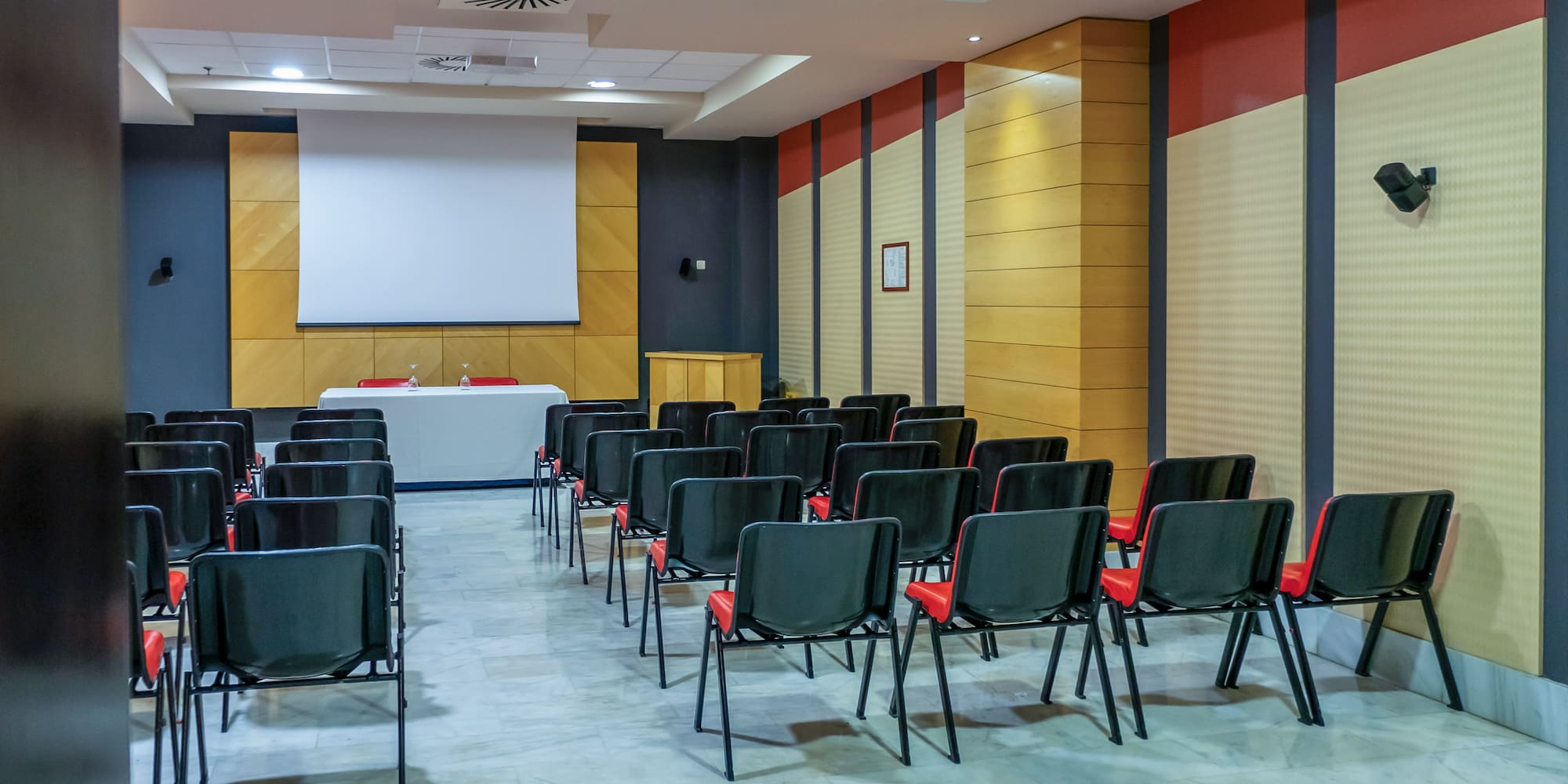 a room with chairs and a projector screen