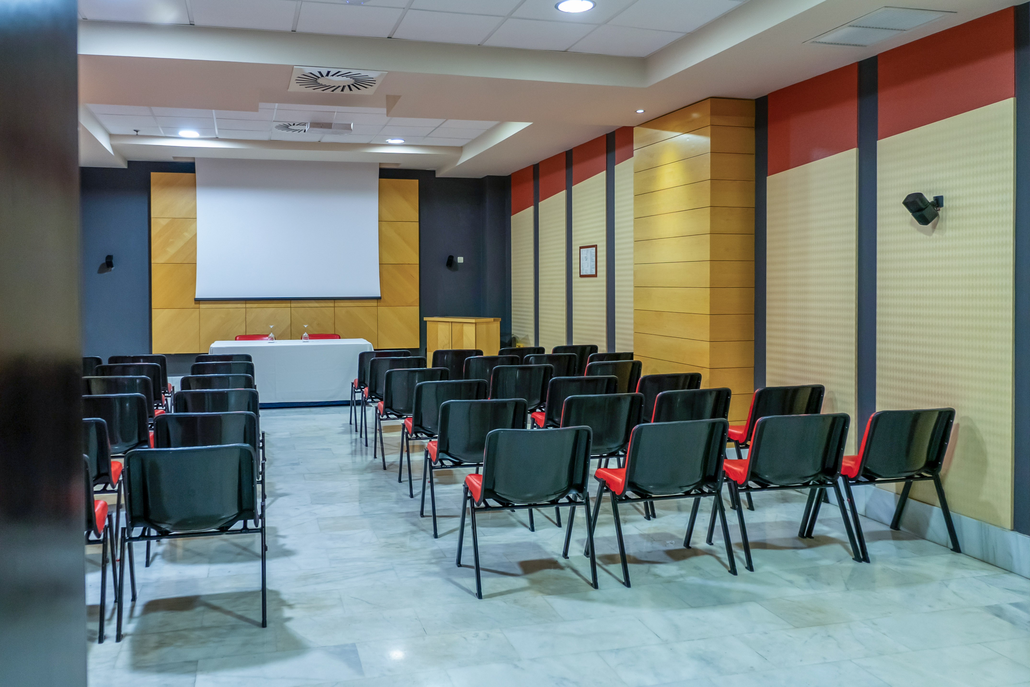 a room with chairs and a projector screen
