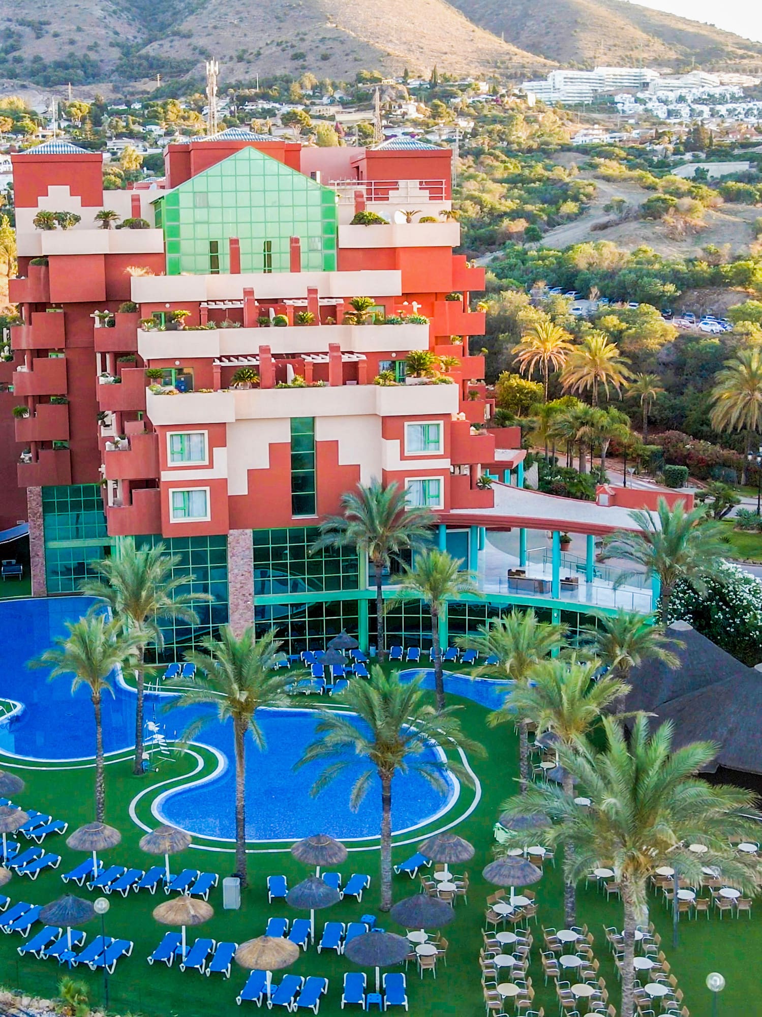 a hotel with a pool and palm trees
