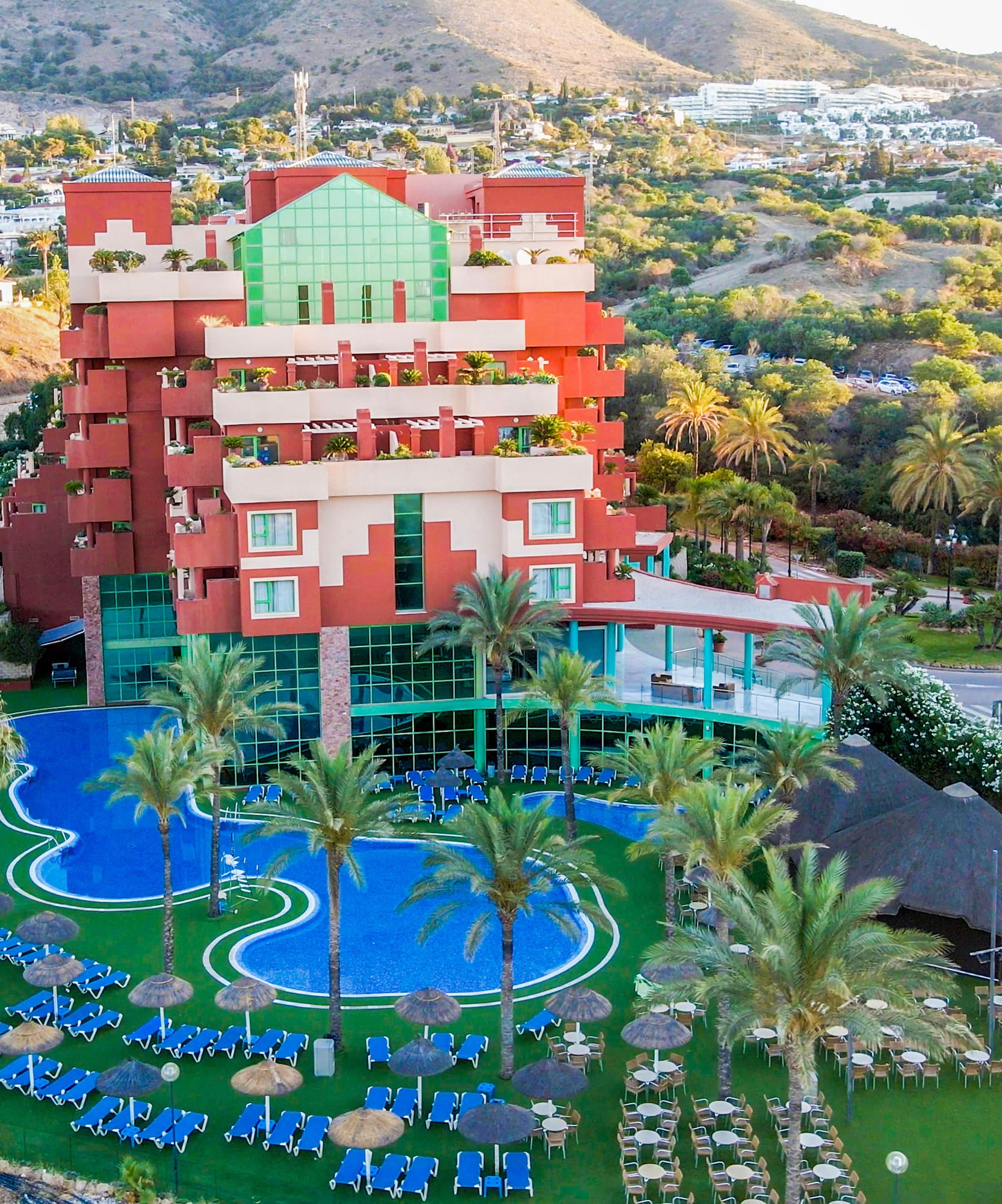 a hotel with a pool and palm trees