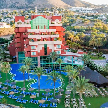 a hotel with a pool and palm trees