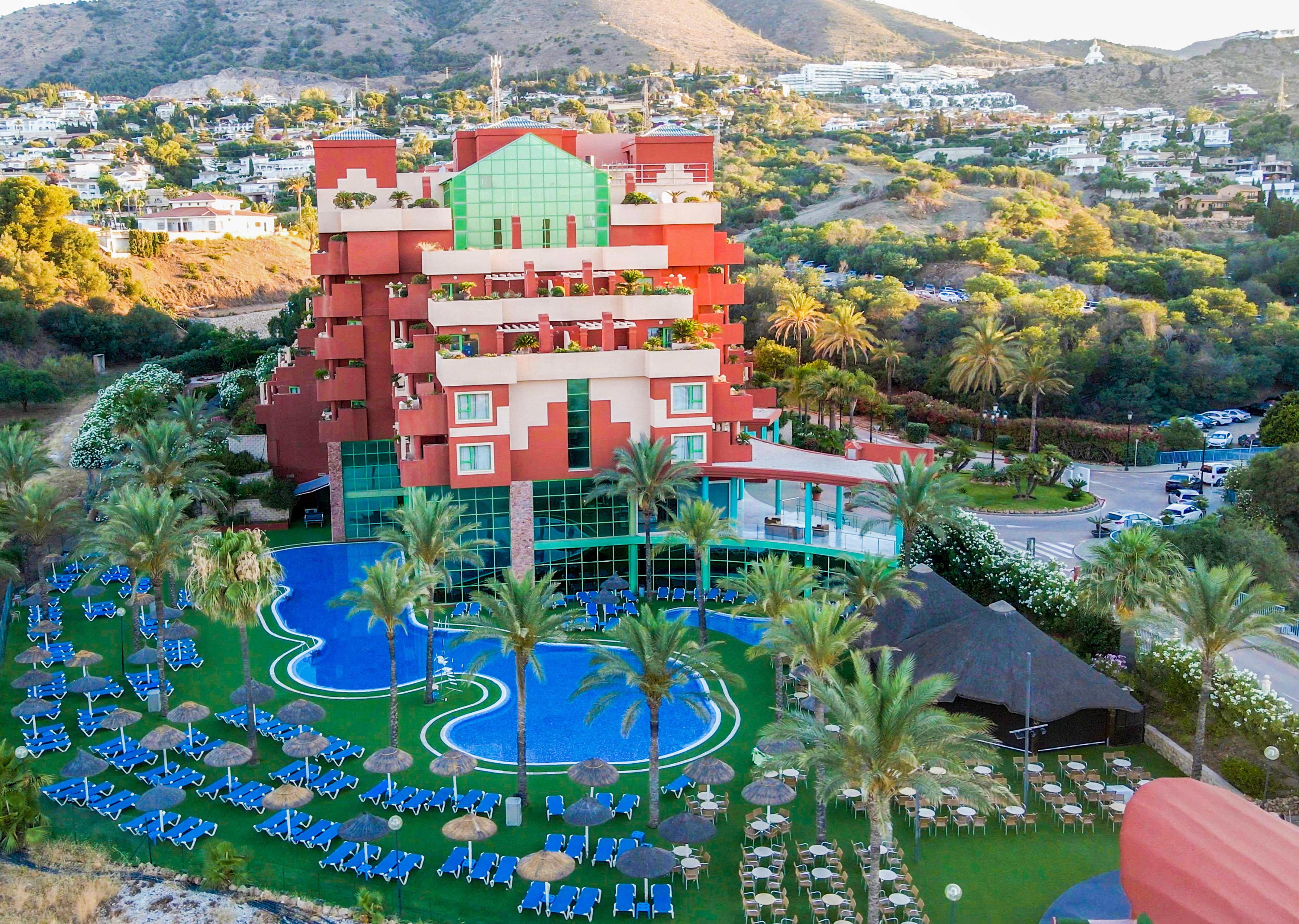a hotel with a pool and palm trees