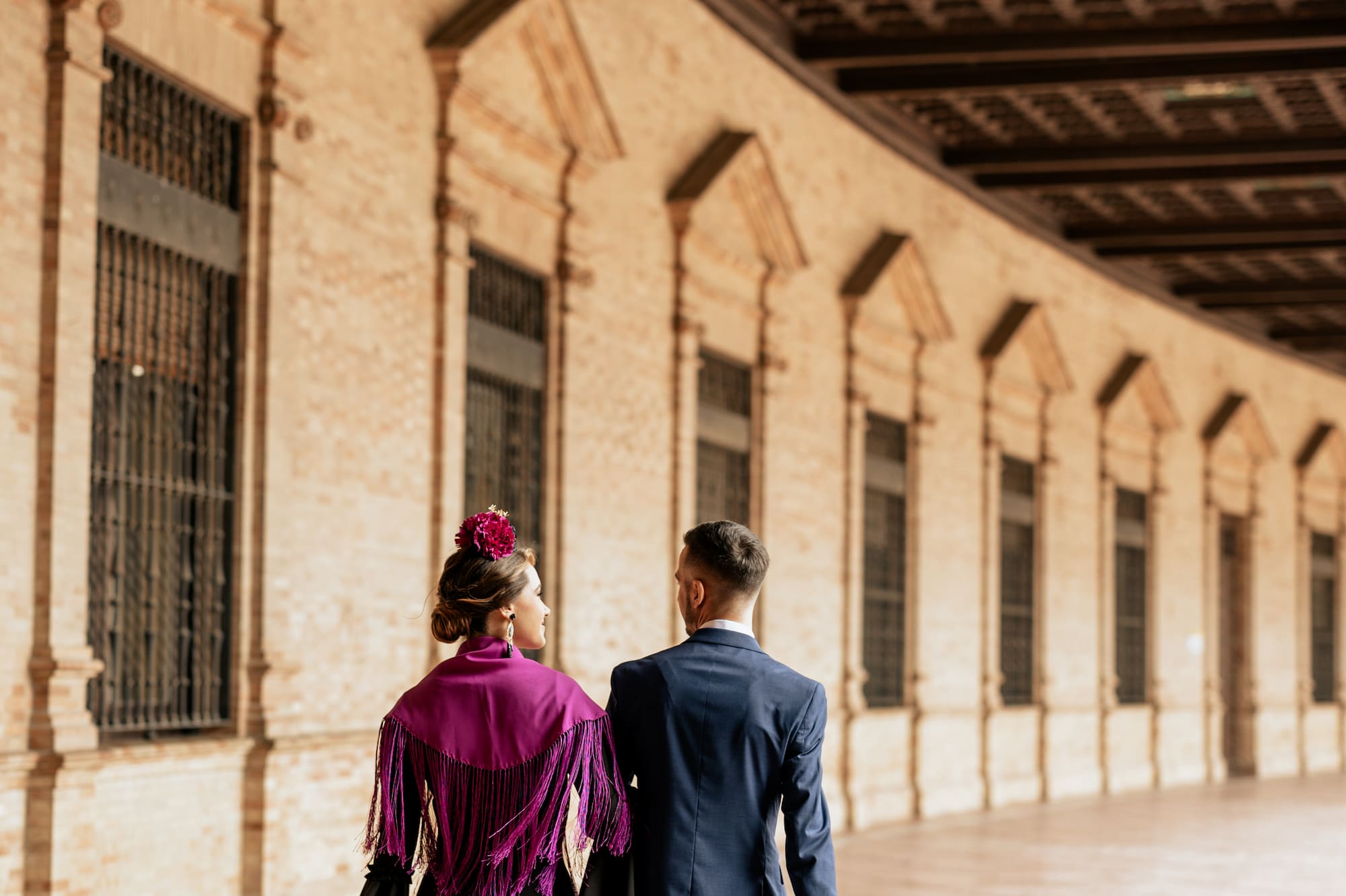 a man and woman walking in a hallway