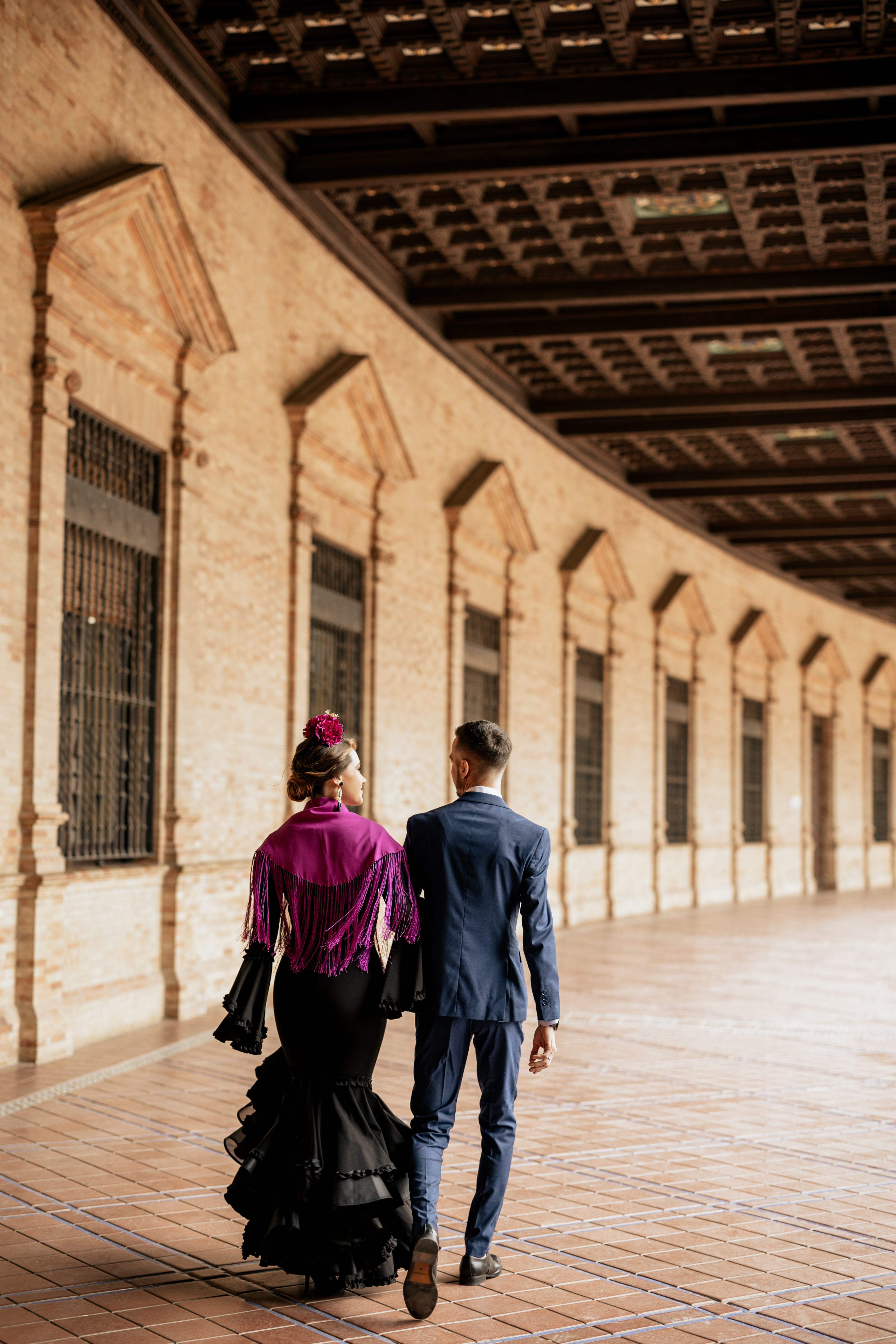 a man and woman walking in a hallway