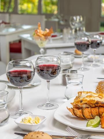 a table with plates of food and glasses of wine