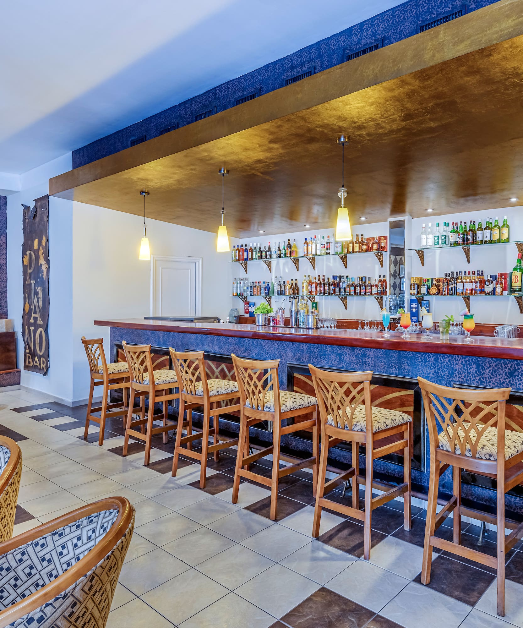 a bar with chairs and a counter